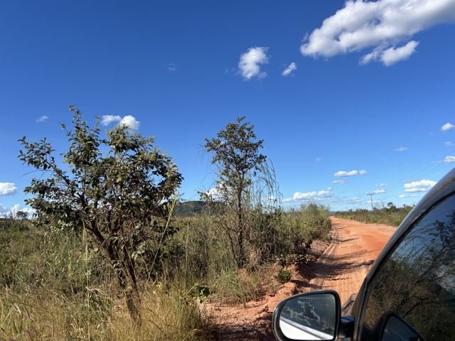 Estrada de terra vermelha rumo às serras